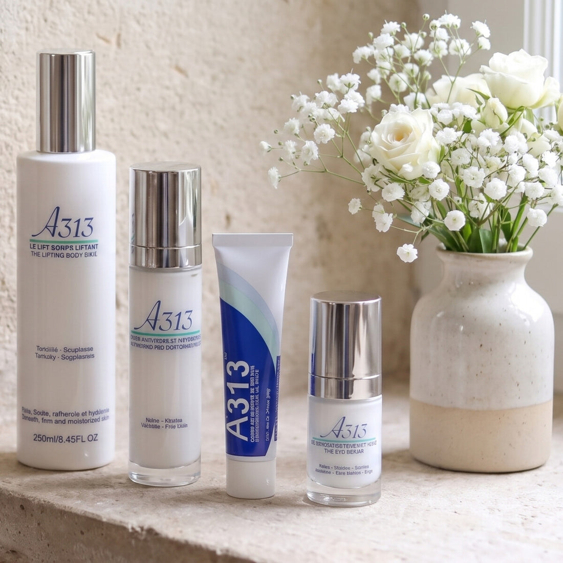 A313 skincare range on a stone windowsill with white flowers